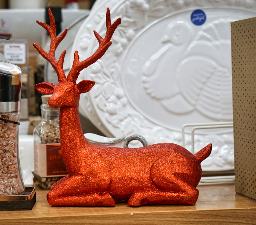 A red glittery deer is on display in the store.