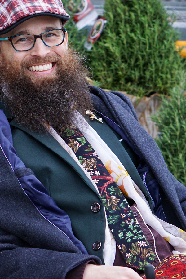 Brad smiles with some rosemary trees in the background.