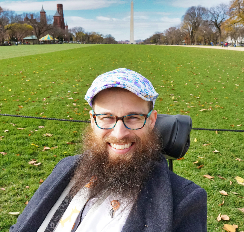 A closeup of Brad with the Washington Monument in the background. His hat is particularly beautiful in this picture.