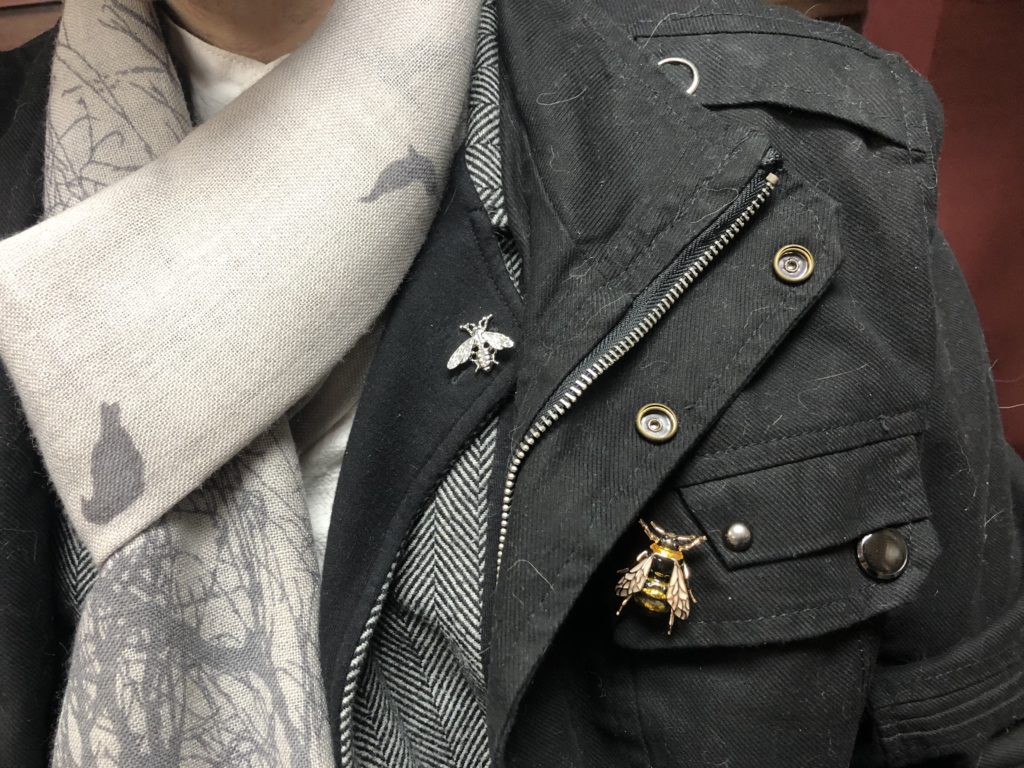 A closeup of the bee pins on Brad's lapel and coat.