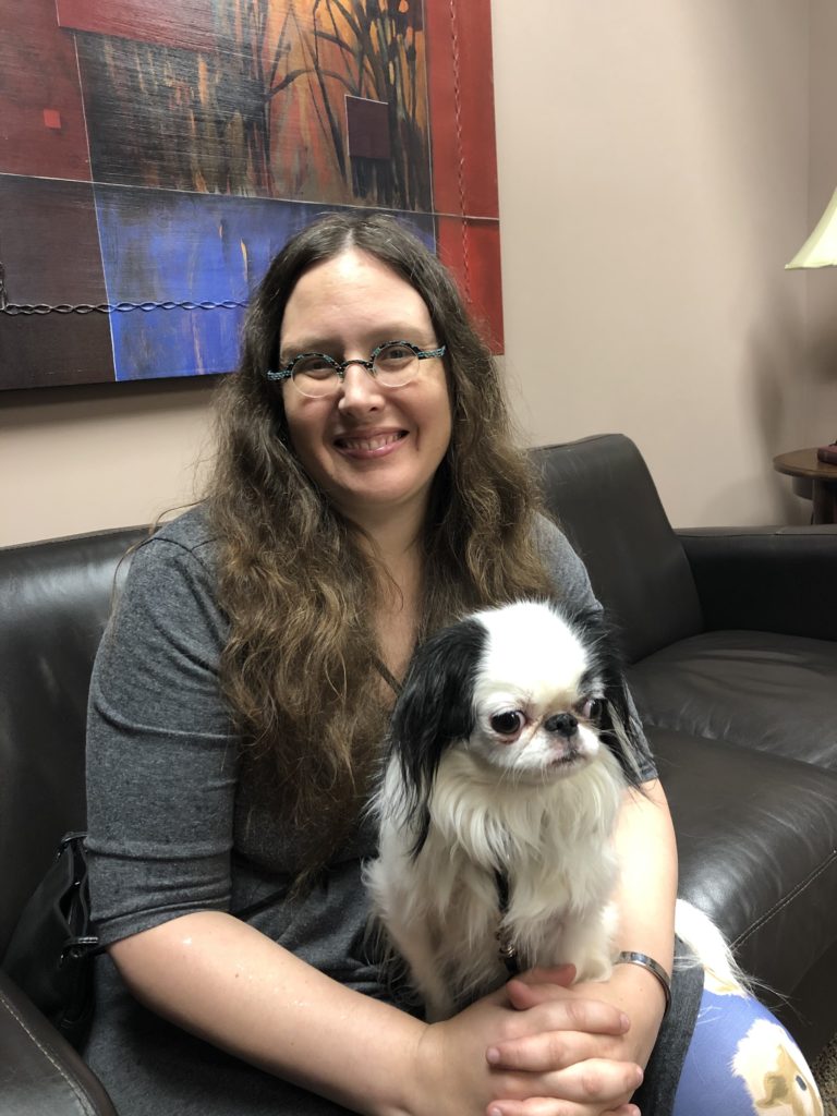 Veronica sits in the waiting room with smelly Hestia on her lap.